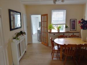 a kitchen and dining room with a table and chairs at Nature and beach in Lowestoft