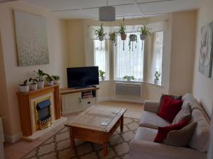 a living room with a couch and a tv at Nature and beach in Lowestoft