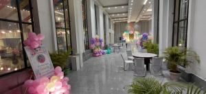 a hallway with tables and balloons in a building at Sparsh Hotel & Resort in Bareilly +4 photos
