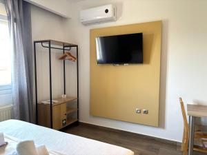 a bedroom with a tv on the wall and a bed at Boho House Florina in Florina
