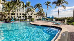 a swimming pool with palm trees and a hotel at THE TIDES 1 bedroom apt 8th floor WE ARE ON THE BEACH in Hollywood +44 photos