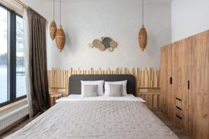 a bedroom with a large bed and a large window at Характер парк in Hatne