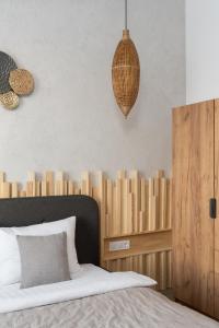 a bedroom with a bed with a wooden headboard at Характер парк in Hatne