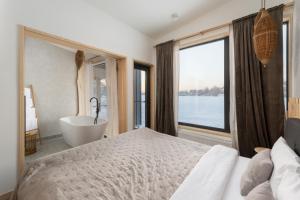 a bedroom with a bed and a bath tub and a window at Характер парк in Hatne