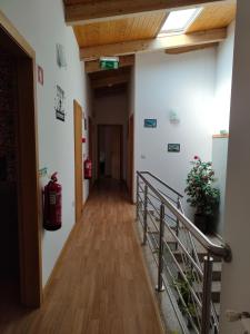 a hallway in a building with a fire extinguisher at Casa do Azibo in Santa Combinha