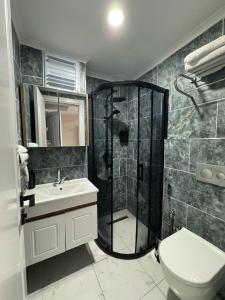 a bathroom with a shower and a toilet and a sink at Dream Hotel in Trabzon