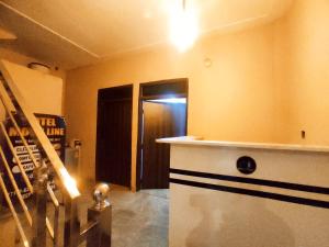a room with a counter and a hallway with a door at ML HOMESTAYS - For Family, Students, Parents, Couples in Phagwāra +8 photos
