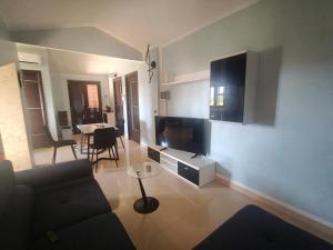 a living room with a couch and a table at La Terrazza in Carrao
