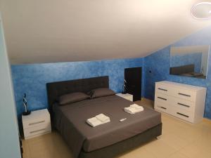 a bedroom with a large bed and a dresser at La Terrazza in Carrao
