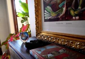 a mirror sitting on a table next to a painting at Chambre confort - Le Boudoir in Hendaye