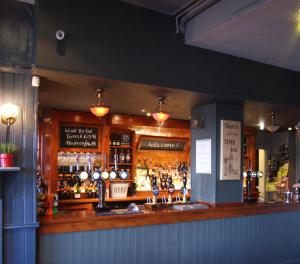 a bar with a lot of bottles of alcohol at Admiral MacBride Bed & Breakfast in Plymouth
