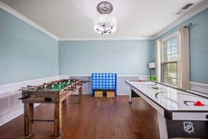 a game room with a table and chessboard at The Blue Crown Manor at Concord Estates in Concord