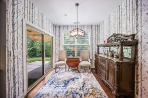 a room with a dresser and two chairs and a mirror at The Blue Crown Manor at Concord Estates in Concord +42 photos
