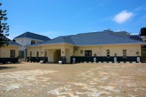 a large house with a brick driveway in front of it at Bgl suites in Barakin Akawo
