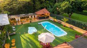 an overhead view of a swimming pool with an umbrella at Roxys Inn in Boca Chica +4 photos