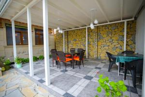 a patio with a table and chairs on a house at Sheki Villa boutique in Sheki