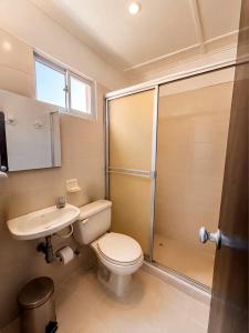 a bathroom with a toilet and a sink and a shower at Renta Mar in Barranquilla