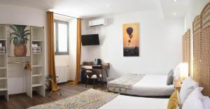 a bedroom with a bed and a desk in a room at Hôtel Du Palais Bastia Centre in Bastia