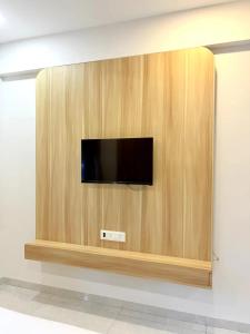 a flat screen tv on a wooden wall at Sukhawan Hotel in Kalamb +10 photos