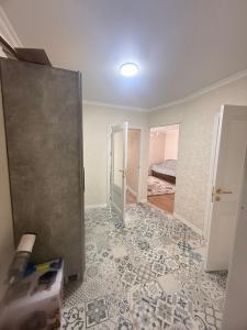 a room being remodeled with a door and a bedroom at Alfaresortappartmens in Koshkolʼ