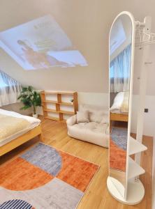 a bedroom with a mirror and a bed and a couch at The Courtyard Heritage Pool Villa Udonthani in Udon Thani +12 photos