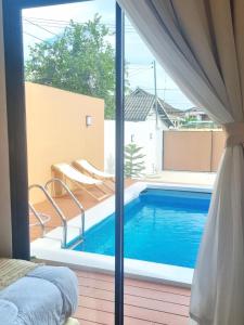 a view of a swimming pool from a bedroom at The Courtyard Heritage Pool Villa Udonthani in Udon Thani