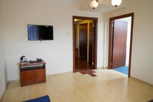a living room with a flat screen tv on a wall at Hotel Sutoris in Bochnia