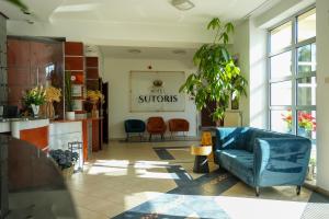 a living room with a blue couch and chairs at Hotel Sutoris in Bochnia