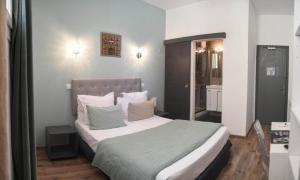 a bedroom with a large bed in a room at Hôtel Du Palais Bastia Centre in Bastia