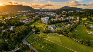 an aerial view of a city with a golf course at The Par Phuket Hotel in Kathu
