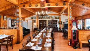 a large dining room with tables and chairs at Top Notch Motel in Wiarton