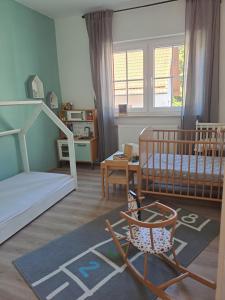 a bedroom with a bunk bed and a chair in it at Ferienwohnung Johanns Hof in Fürth