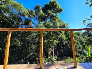 a wooden deck with trees in the background at Studio Mata dos Curiós in Petrópolis