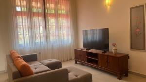 a living room with a flat screen tv and a couch at Kasitha Ocean View Villa - Matara Beach Road in Matara