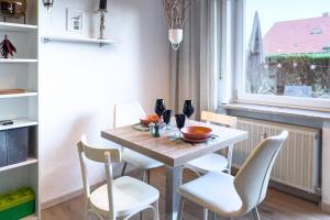 a table and chairs in a kitchen with a window at Am Silberbergblick in Bodenmais +7 photos