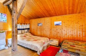 a bedroom with a bed in a wooden room at chambre pour 2 à 4 personnes ,balcon in Mont-Saxonnex