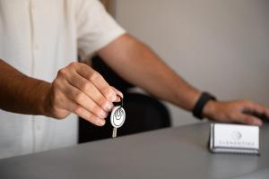 a person is holding a car key on a table at Clementina Hill in Naousa