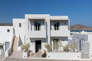 a white house with a view of the ocean at Clementina Hill in Naousa