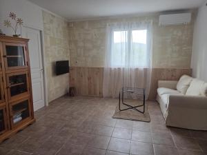 a living room with a couch and a tv at A Casa POGGIOLI in Rogliano