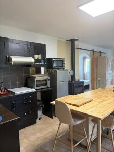 a kitchen with a wooden table and a dining room at A Casa POGGIOLI in Rogliano