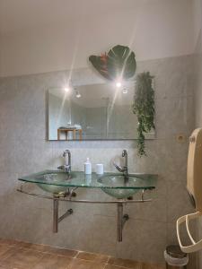 a bathroom with two sinks and a mirror at A Casa POGGIOLI in Rogliano +29 photos