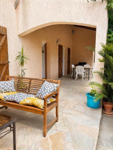 a wooden bench sitting on a patio at A Casa POGGIOLI in Rogliano