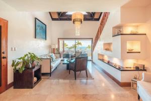 a living room with a couch and a table at Gorgeous PH at Puerto Bahia in Santa Bárbara de Samaná