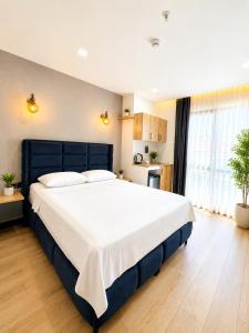 a large bedroom with a large bed with white sheets at Dream Hotel in Trabzon