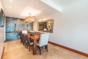 a dining room with a wooden table and chairs at Gorgeous PH at Puerto Bahia in Santa Bárbara de Samaná