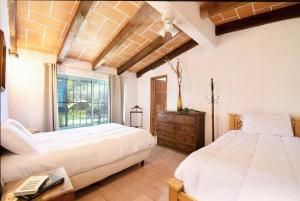 a bedroom with two white beds and a window at Geodesic sanctuary with a heated pool in Chiconcuac +93 photos