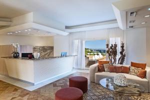 a living room with a couch and a table at L'Ea Bianca Luxury Resort in Baja Sardinia