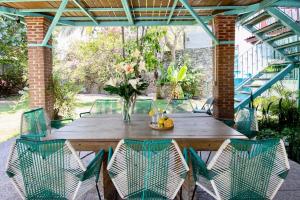 a wooden table and chairs on a patio at Geodesic sanctuary with a heated pool in Chiconcuac