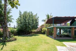 a view of the yard of a house with a pavilion at Geodesic sanctuary with a heated pool in Chiconcuac