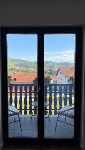 a view from a window of a balcony with chairs at Nikola apartman in Arilje